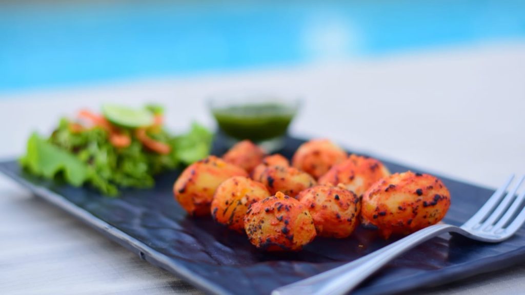 Small potatoes with skin slowly roasted with local spices Angaari Aloo